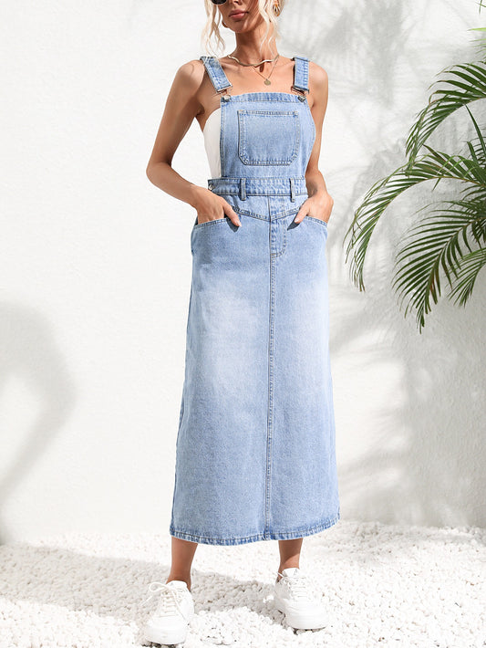 Woman wearing a light blue denim dress against a white background with a plant on the right. Women wearing tight waist strap mid-length denim dress with kurti