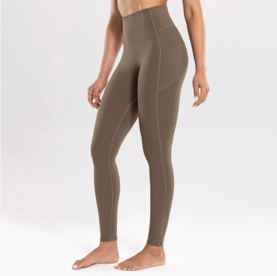 Olive green leggings worn by a person on a white background