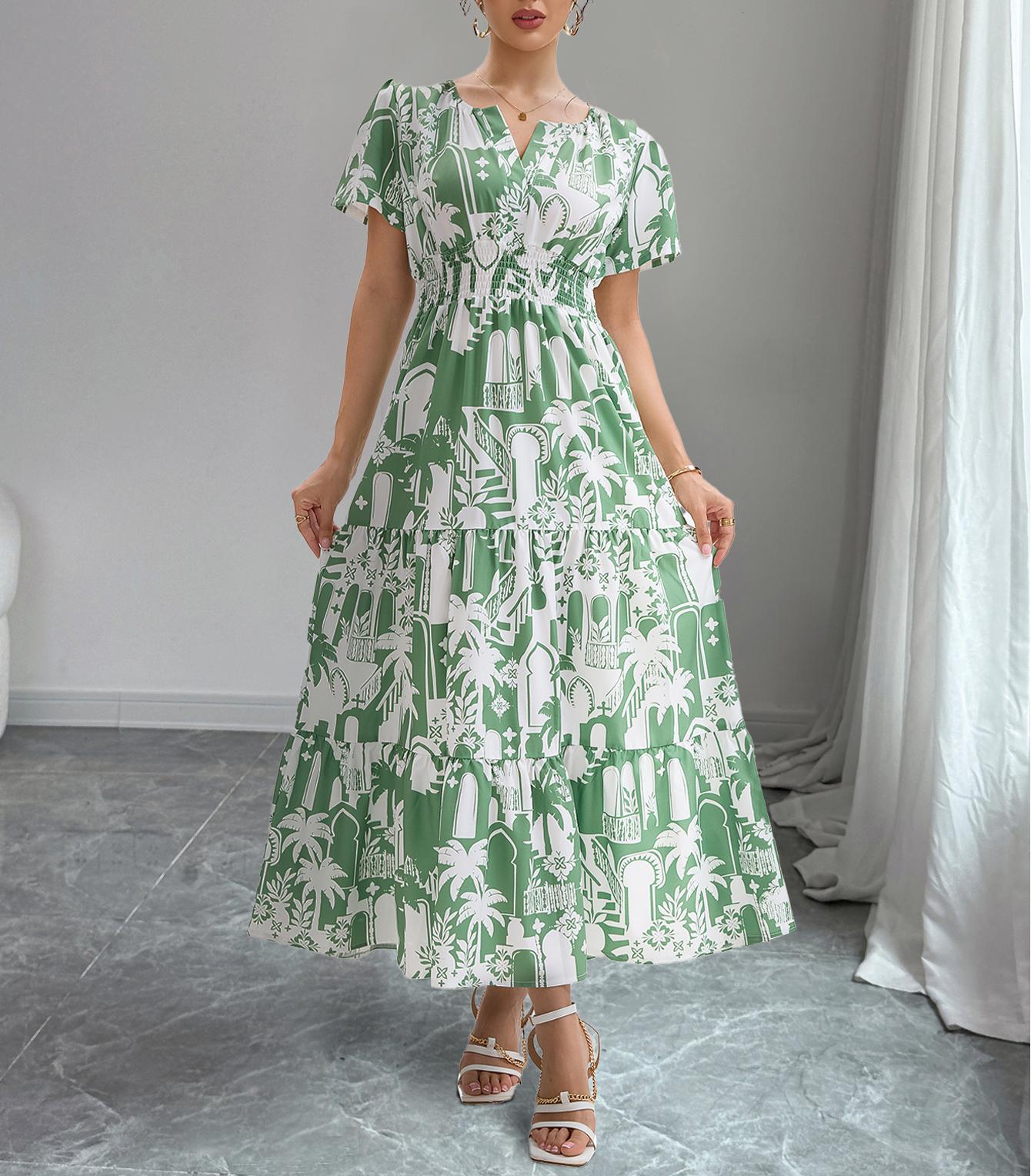 Woman wearing a green and white patterned dress in a room with gray flooring and white curtains.