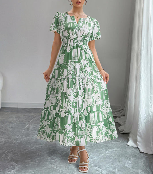 Woman wearing a green and white patterned dress in a room with gray flooring and white curtains.
