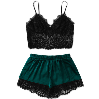 Black lace camisole and teal satin shorts on a white background