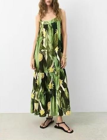 Woman wearing a green floral dress against a white background