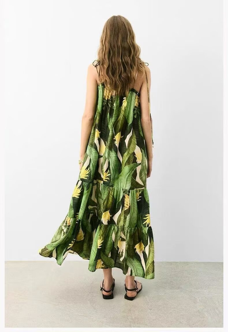 Woman wearing a green floral dress with a white background