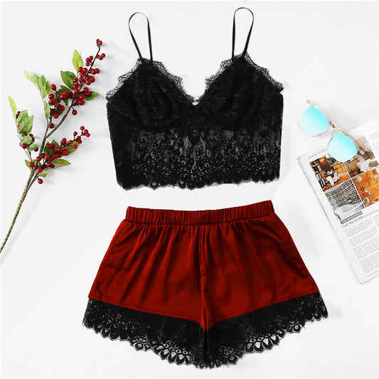 Black lace top and red shorts with black lace trim on a white background.