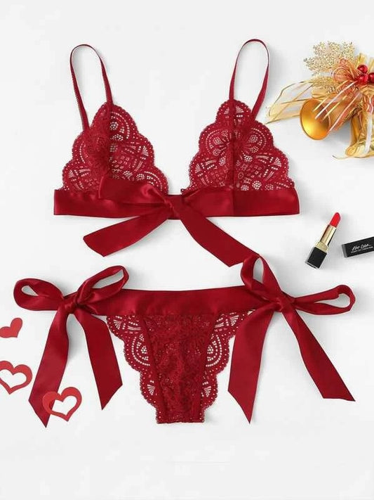 Red lace lingerie set with ribbons on a white background