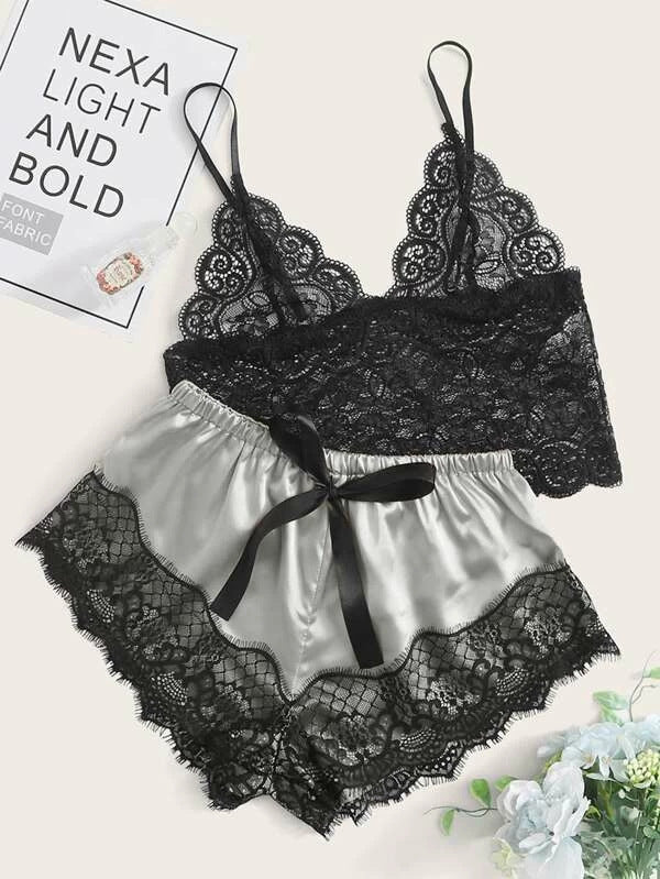 Black lace lingerie set with satin accents on a white background