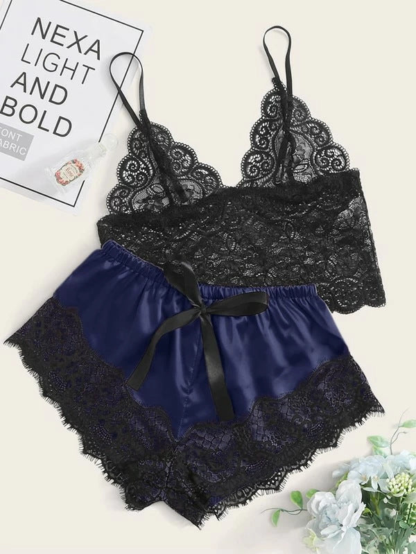Black lace lingerie set with blue satin bottom on a light background