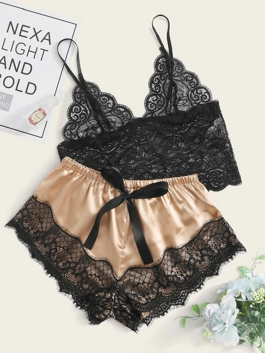 Black lace lingerie set with beige satin shorts on a white background
