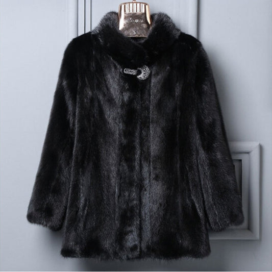 Black fur coat on a hanger against a gray background