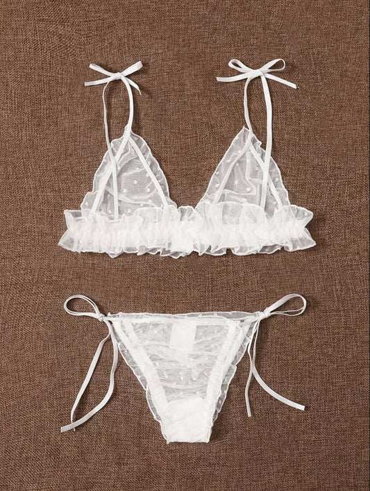 White lace bikini set on a brown fabric background