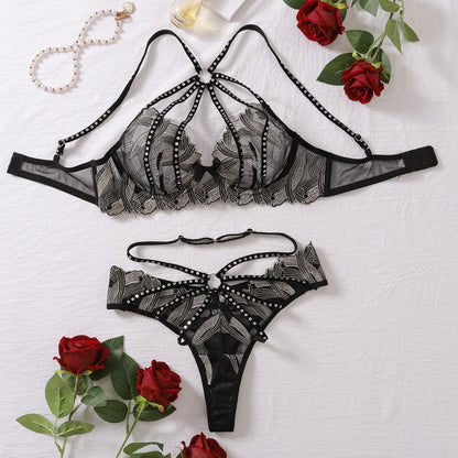 “complete lace embroidery gathered hollow-cut underwear set laid flat showing bra and panty with steel ring hardware”