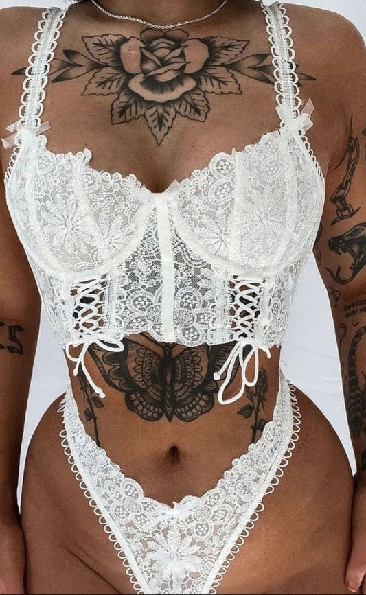 Close-up of the intricate lace splicing and handmade satin ties on the lingerie set