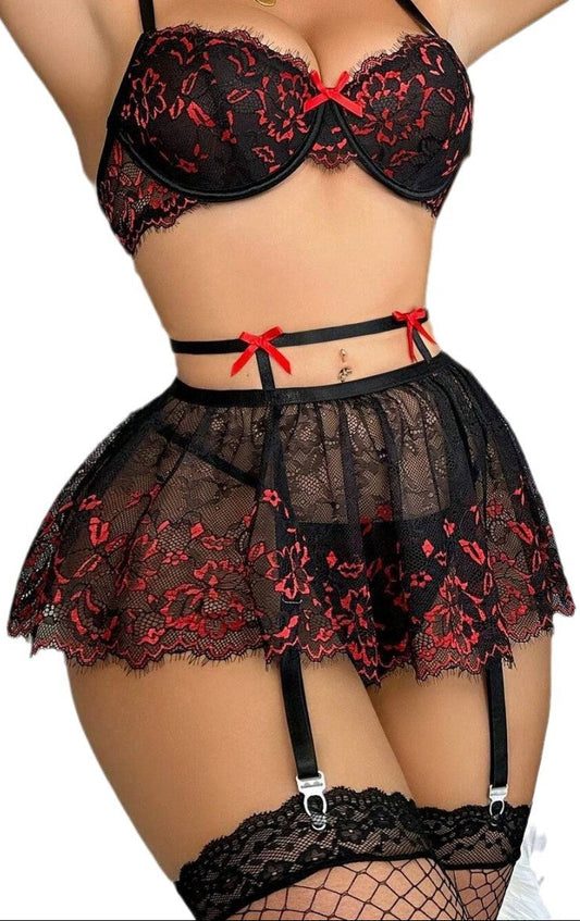 “Plus size backless lace bra with matching panties, garter, and stockings front view”