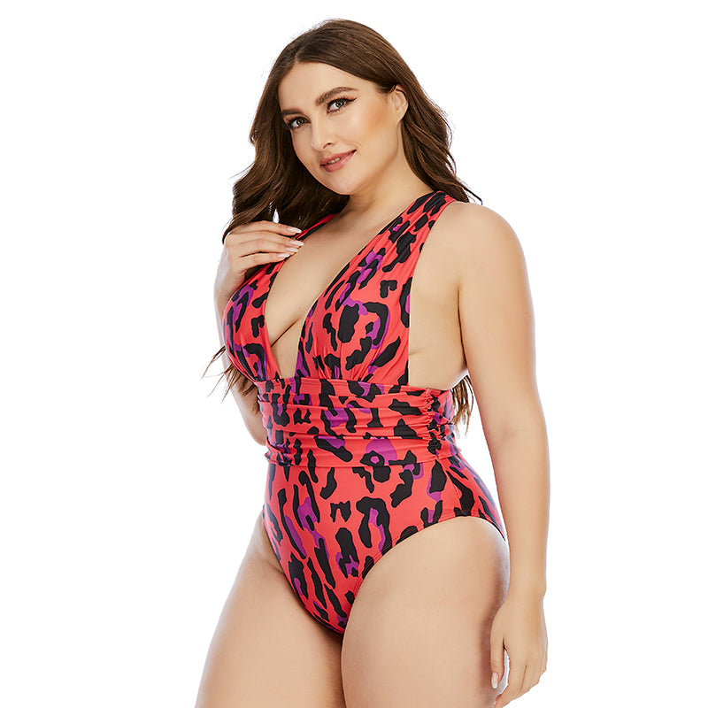 Woman wearing a pink leopard print swimsuit on a white background
