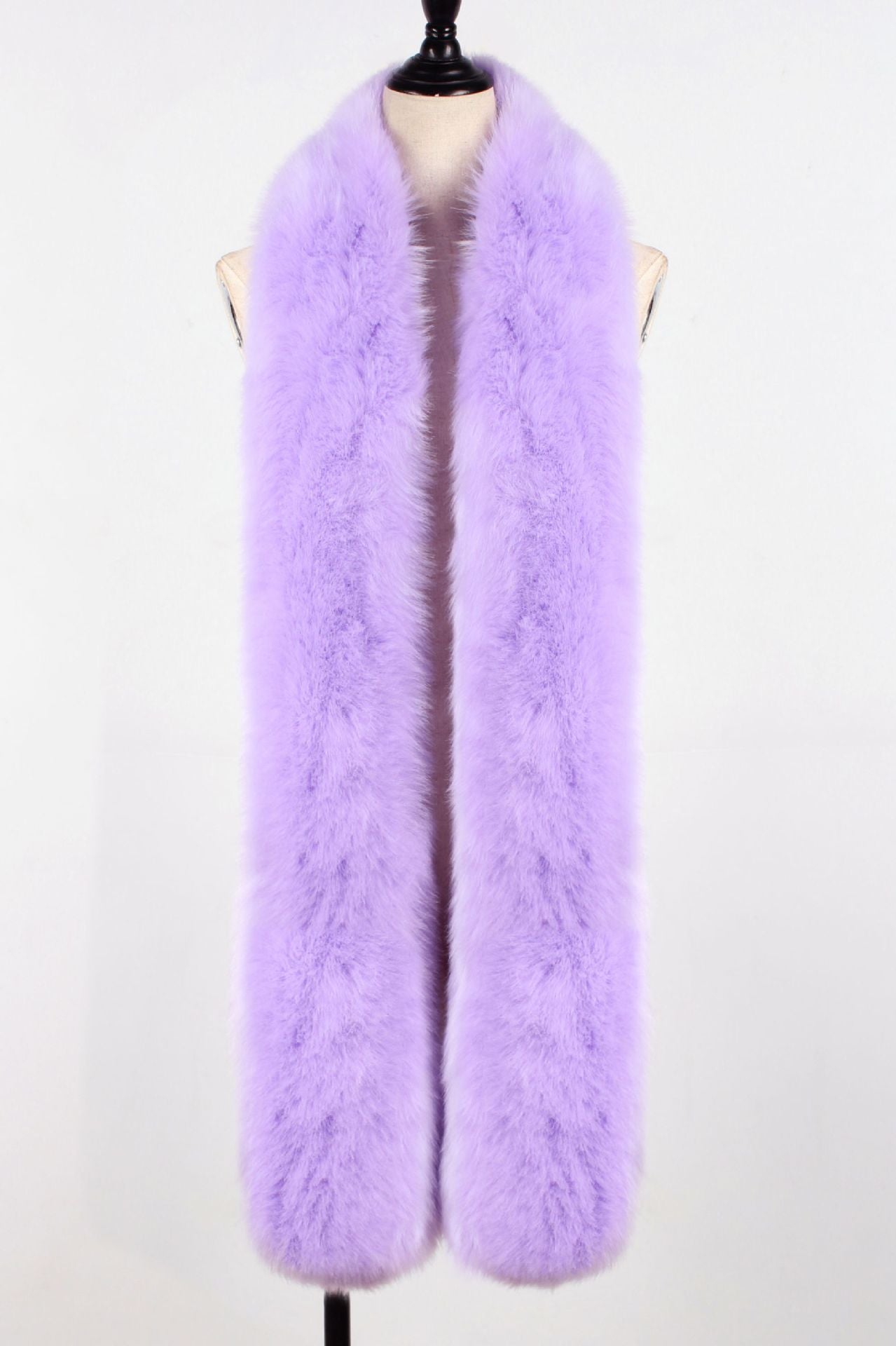 Curvy woman wearing a long faux fox fur scarf draped as a shawl over winter coat