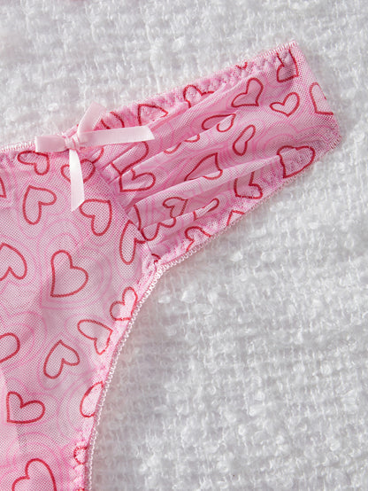 Pink underwear with red heart patterns on a white background