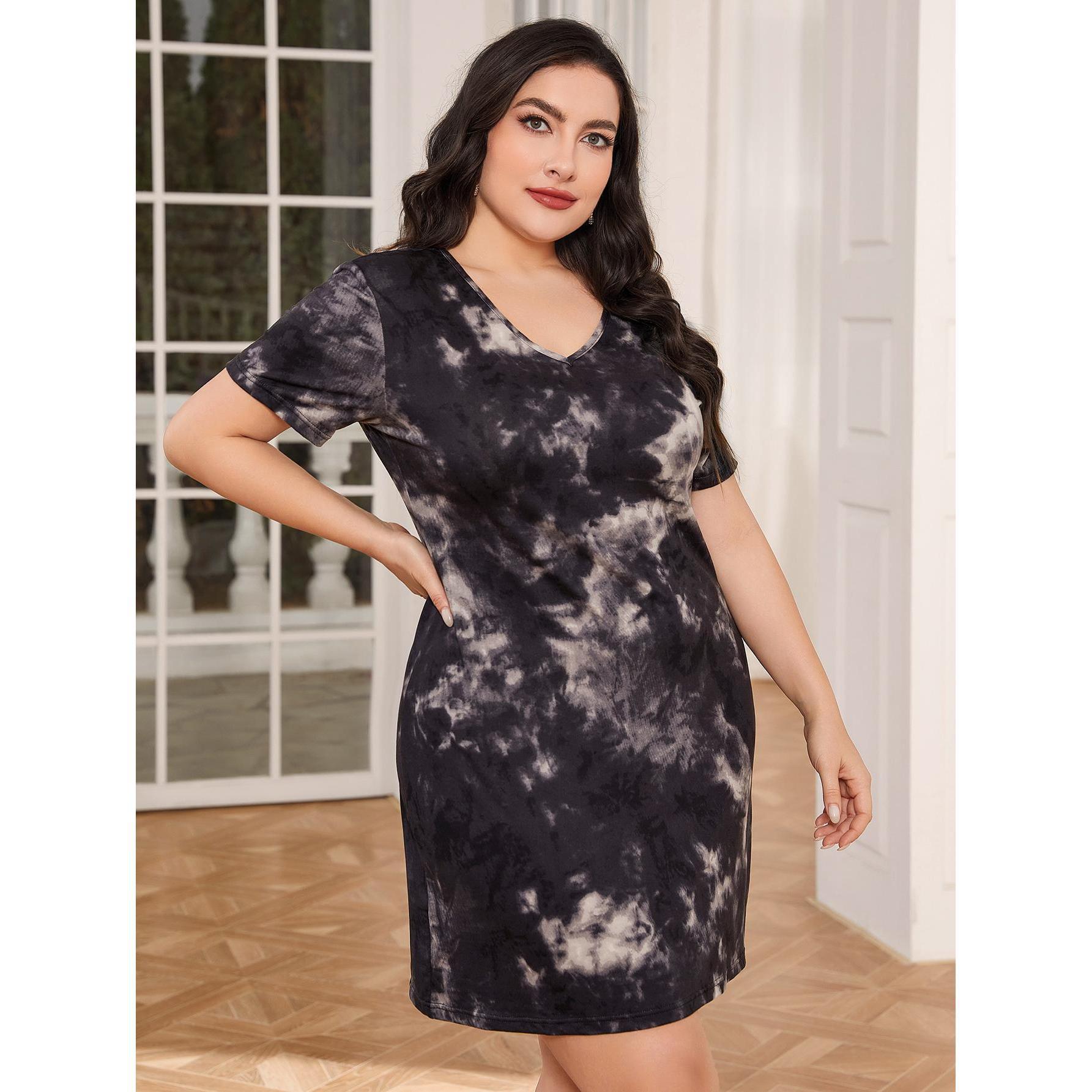 Woman wearing a black and gray tie-dye dress indoors.