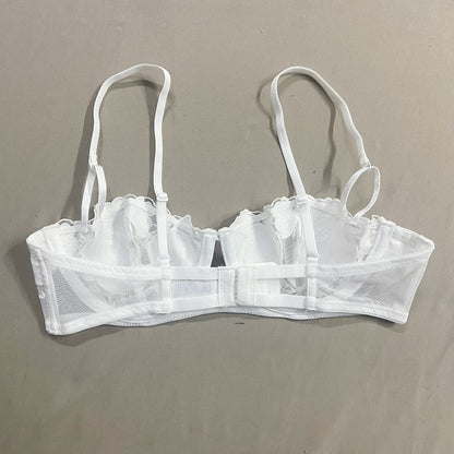 White bra with mesh design on a beige background