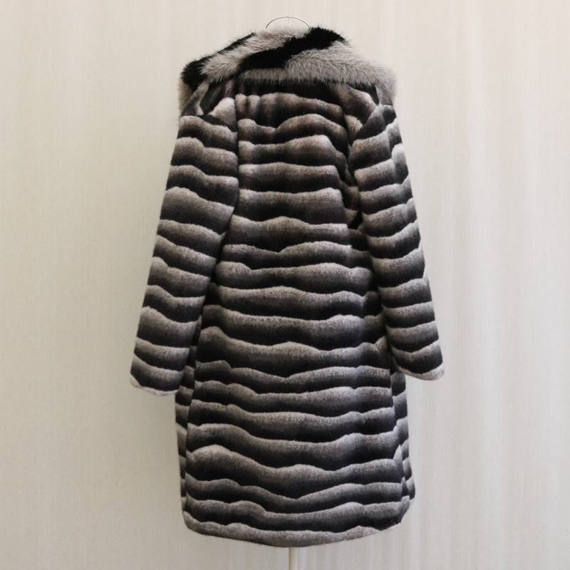 Striped fur coat on a hanger against a plain background