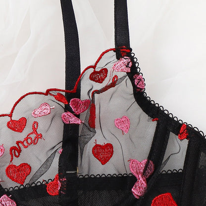 Embroidered lingerie with red and pink hearts and 'I love you' text on a white background