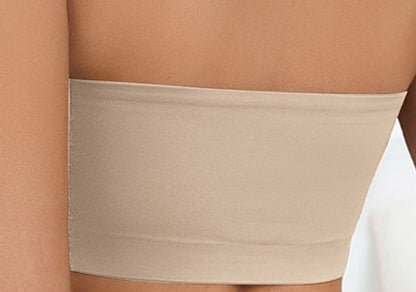 Beige strapless top worn by a person on a white background