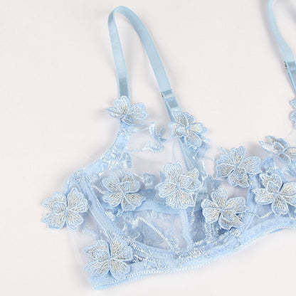 Light blue bra with floral lace details on a white background