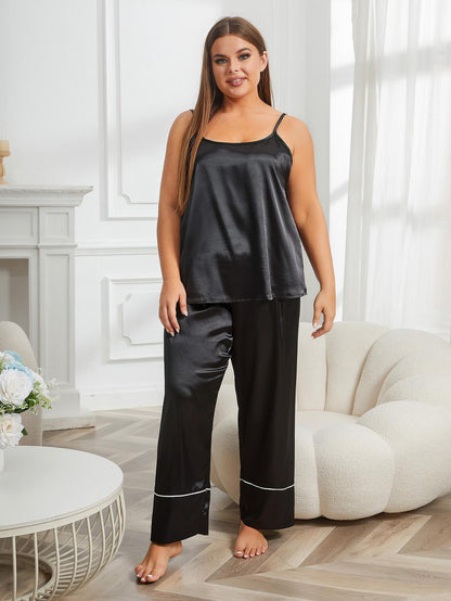 Woman wearing a black satin pajama set in a bright living room.