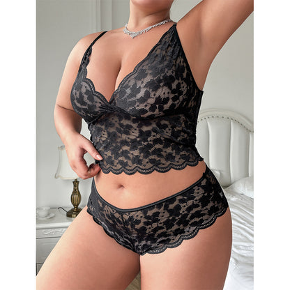 Black lace lingerie set worn by a model in a bedroom setting