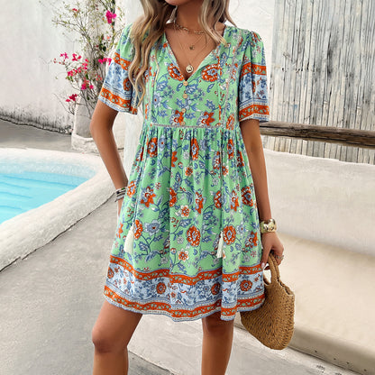 Woman wearing a colorful floral dress by a poolside