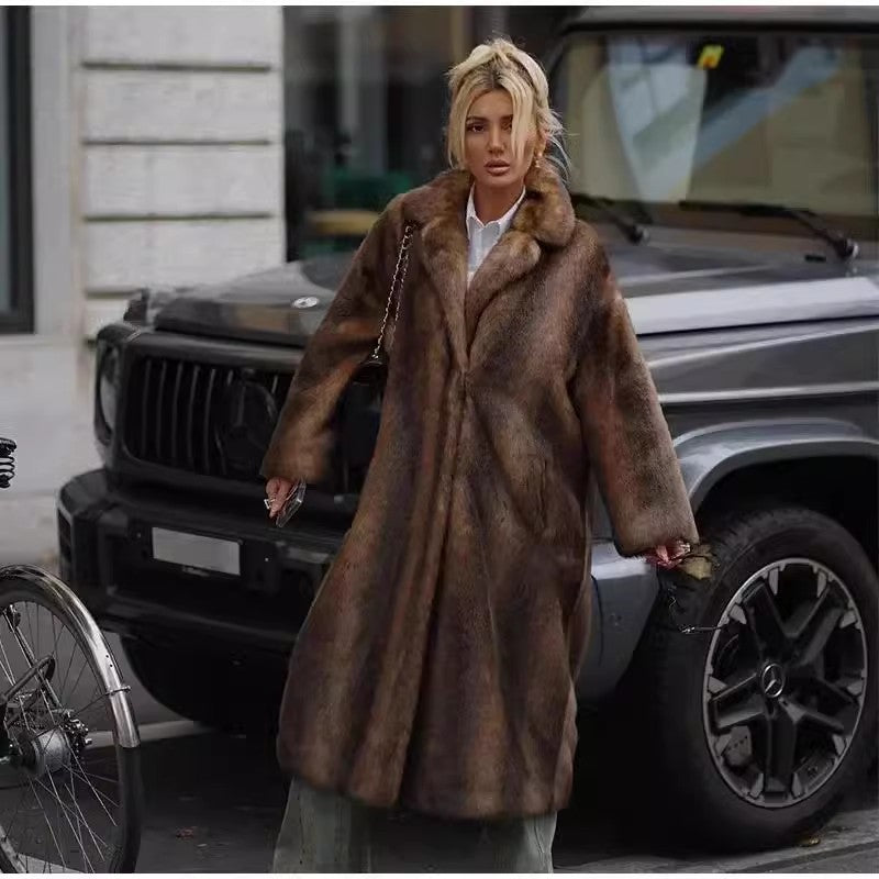 Person wearing a fur coat standing in front of a vehicle