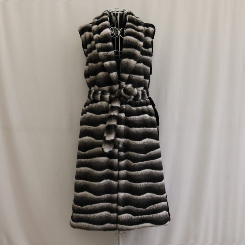 Long quilted vest with a pattern on a plain background