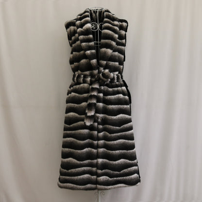 Long quilted vest with a pattern on a plain background