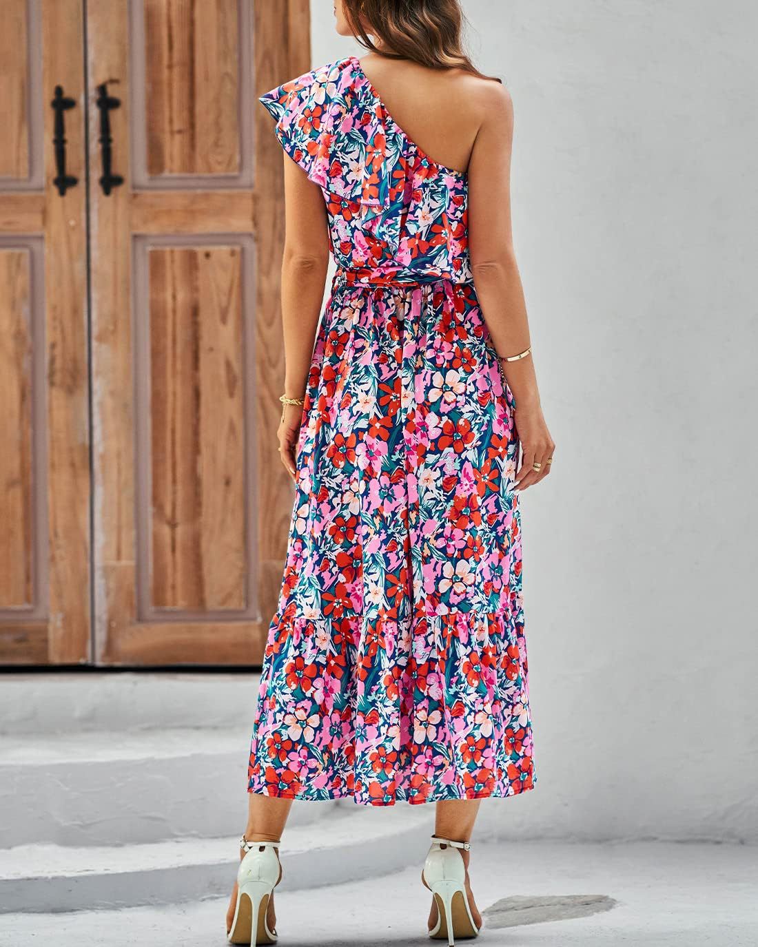 Woman wearing a colorful floral one-shoulder dress against a wooden door background