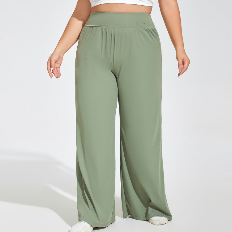 Green wide-leg pants worn by a person on a white background