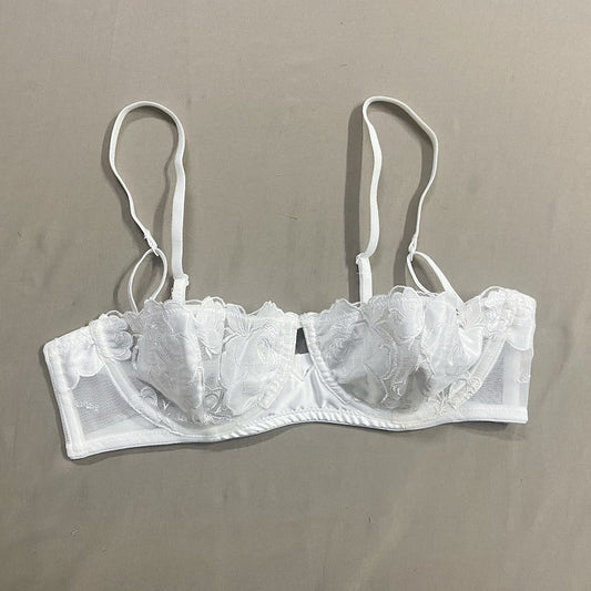 White lace bra on a beige background