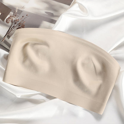 Beige strapless top on a white fabric background
