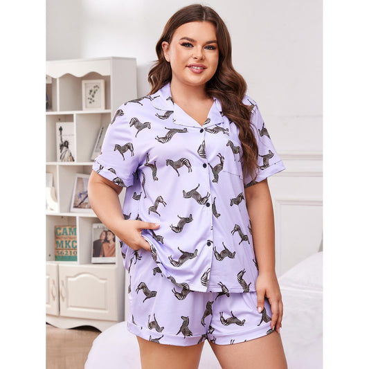 Woman wearing a light purple pajama set with animal prints in a bedroom setting.