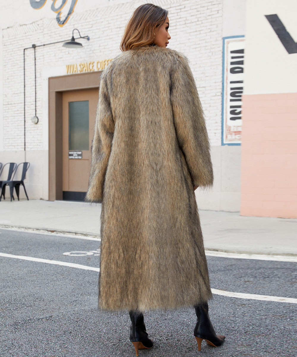 Woman wearing a long fur coat walking on a street.