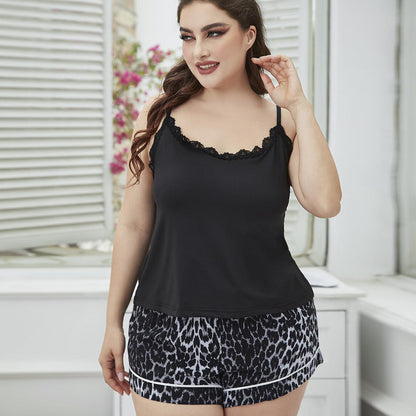 Woman wearing a black tank top and leopard print shorts in a bright room.