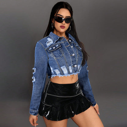 Woman wearing a denim jacket and black pleated skirt against a gray background Women cowboy ripped tassel denim jacket with distressed details