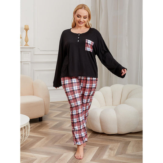 Woman wearing a black top and red plaid pants in a living room.