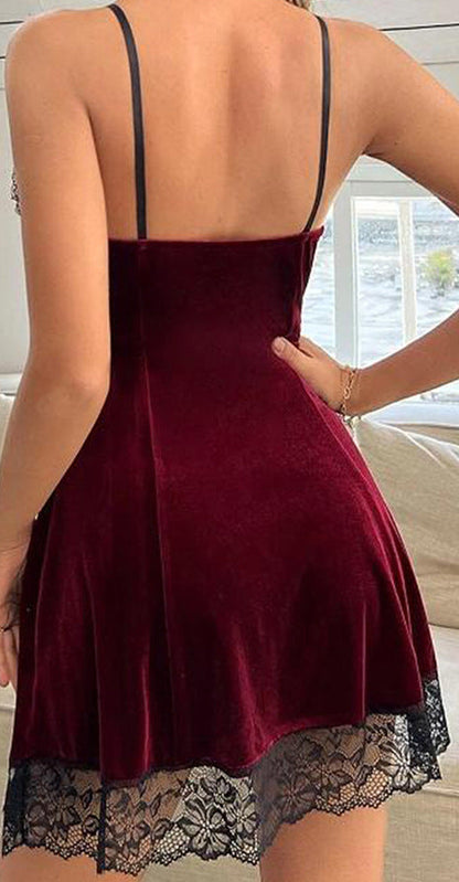 Burgundy nightgown with lace hem worn by a person, sitting on a couch.