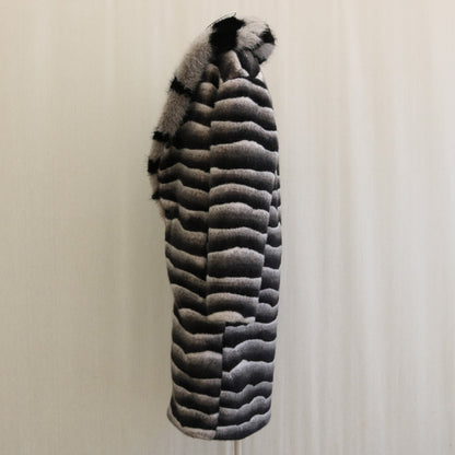 Striped fur coat on a mannequin against a plain background