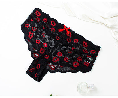 Black lace lingerie with red accents on a white background