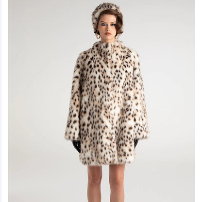 Model wearing a leopard print coat and hat on a plain background