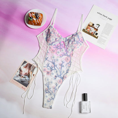 Floral dress with a pink and purple gradient background, featuring a pastry, magazine, and perfume bottle.