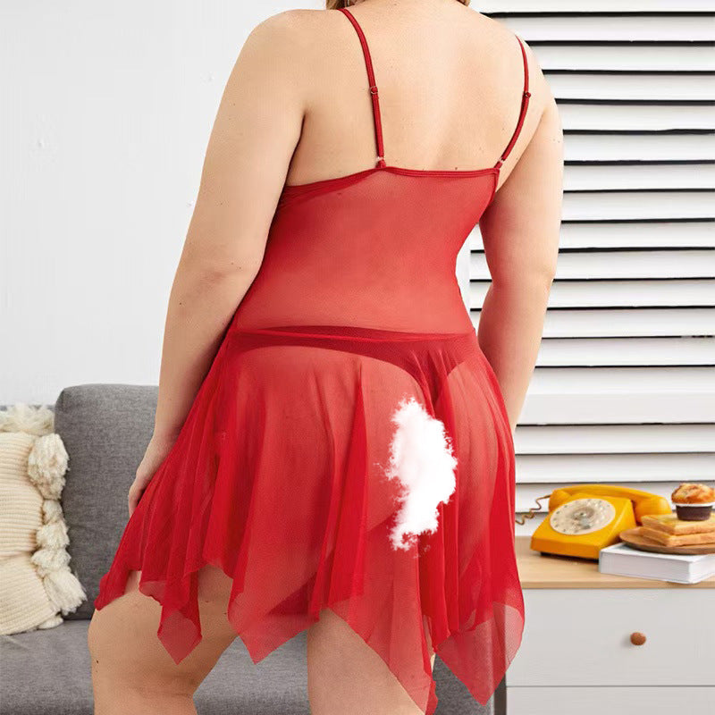 Person wearing a red lace nightgown with a white feather detail, standing in a room with a gray couch and wooden table.