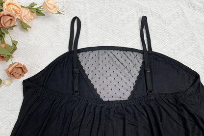 Black lace top on a textured surface with flowers around