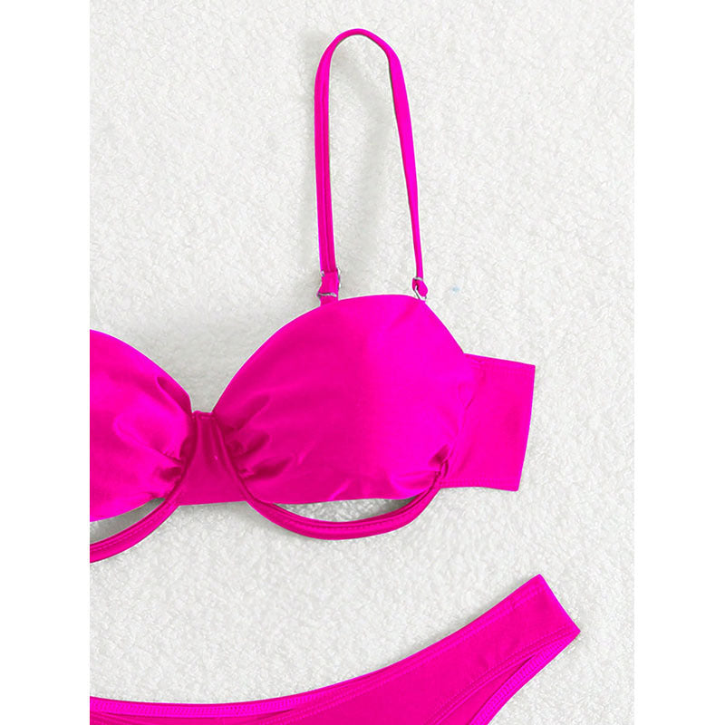 Pink bikini top on a textured white background