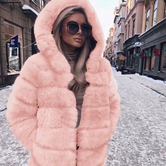 Person wearing a pink fur coat on a city street.